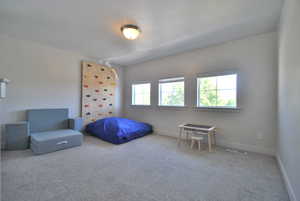 Bedroom featuring carpet flooring and baseboards