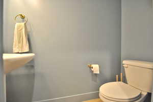 Half bath with toilet and baseboards