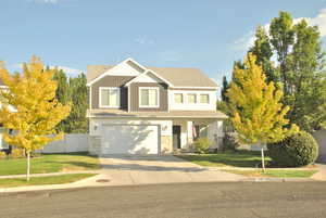 Craftsman house with concrete driveway, covered porch, an attached garage, roof with shingles, and stone siding
