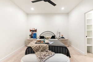 Bedroom featuring light carpet, recessed lighting, ceiling fan, and a desk