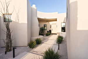 Entrance to property with stucco siding