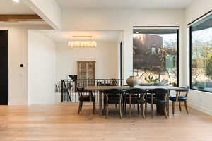 Dining space with light wood-style flooring and baseboards