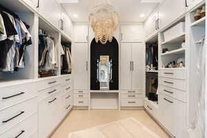 Walk in closet with a chandelier