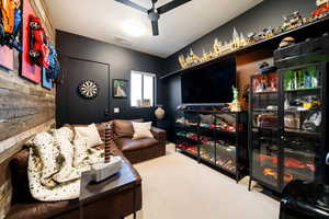 Carpeted living room featuring a ceiling fan