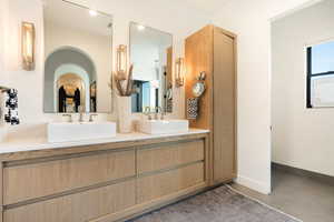 Full bath with double vanity and tile patterned flooring