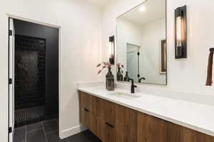Full bath with vanity, a shower stall, dark tile patterned floors, and recessed lighting