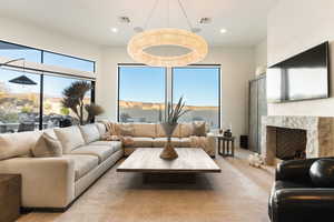 Living room featuring plenty of natural light, wood finished floors, recessed lighting, and a fireplace