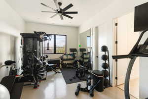 Workout room featuring a ceiling fan and recessed lighting