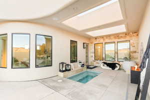 View of pool with an in-ground hot tub