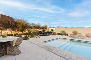 View of swimming pool with a patio and a fenced backyard