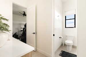 Bathroom featuring vanity, light tile patterned flooring, and ceiling fan