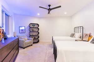 Bedroom with light carpet, a ceiling fan, and recessed lighting