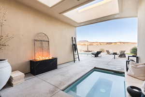 View of swimming pool with a patio, a fenced backyard, an in-ground hot tub, and a mountain view