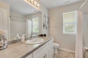 Bathroom with vanity and a shower with curtain