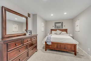 Bedroom featuring light carpet and recessed lighting