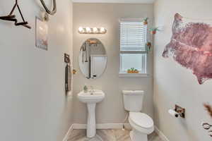 Bathroom featuring toilet and baseboards