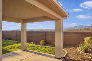 Fenced backyard featuring a patio and a mountain view