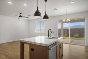 Kitchen with light wood-style floors, dishwasher, decorative light fixtures, recessed lighting, and a ceiling fan
