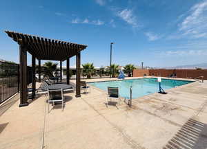 Community pool with a pergola and a patio area