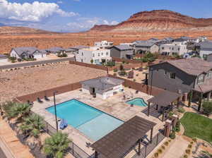 Community pool with a patio area, a mountain view, and a residential view
