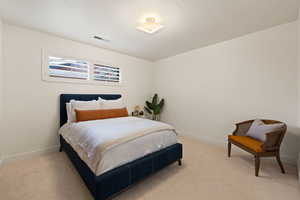 Bedroom featuring light colored carpet and baseboards