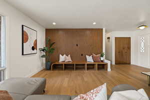 Living area with plenty of natural light, light wood-type flooring, and recessed lighting
