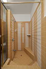 Full bath featuring a stall shower and tile patterned floors