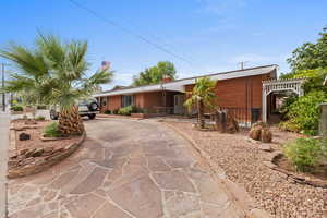 Ranch-style house with brick siding, driveway, and a chimney