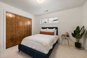Carpeted bedroom with a closet and baseboards