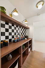 Wine cellar featuring light wood finished floors