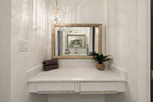 Bathroom featuring vanity and a chandelier