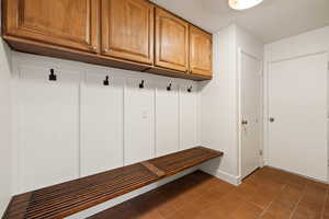 Mudroom featuring dark tile patterned flooring
