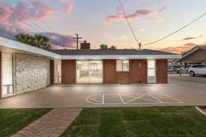 View of front facade with a chimney, a front lawn, and brick siding
