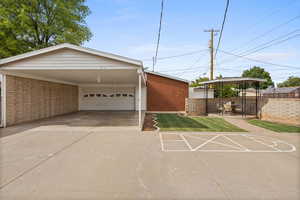 View of front of property featuring driveway, brick siding, and an attached carport