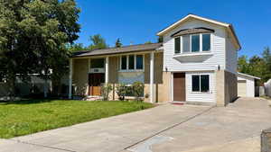View of front of house with brick siding and driveway