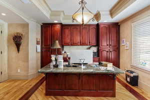 Home office featuring light wood finished floors, recessed lighting, ornamental molding, and a textured ceiling
