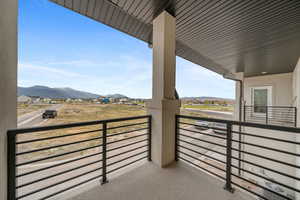 Balcony off primary bedroom featuring a mountain view