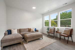 Living area with light wood finished floors and baseboards