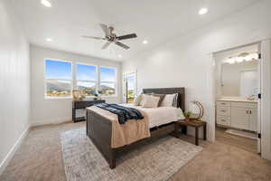 Primary Bedroom featuring light carpet, a mountain view, connected bathroom, recessed lighting, and ceiling fan