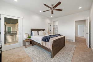 Primary Bedroom with light carpet, recessed lighting, a spacious closet, door to balcony, and ceiling fan