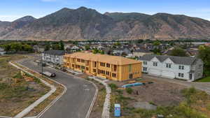 Aerial view of residential area featuring a mountainous background