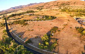 Aerial view of property and surrounding area with a mountain backdrop and rural landscape
