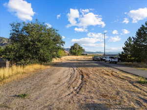 View of dirt / gravel road featuring a mountain view and a rural view