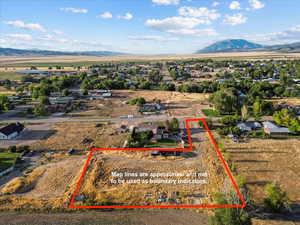 Aerial view of sparsely populated area featuring a mountain backdrop and property boundaries highlighted
