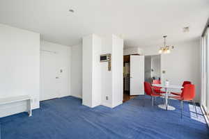 Living area with a chandelier and carpet