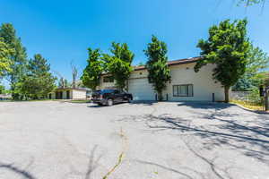 View of front facade featuring asphalt driveway and a garage