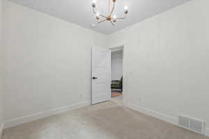 Unfurnished dining area featuring carpet and a chandelier