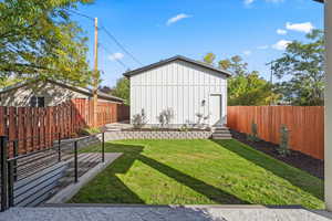 Fenced backyard with entry steps