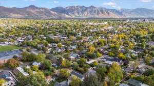 Aerial view of property and surrounding area with nearby suburban area
