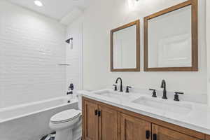 Bathroom featuring tub / shower combination, double vanity, tile patterned floors, and recessed lighting